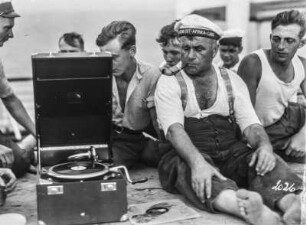Matrosen mit Plattenspieler : Matrosen sitzen an Deck um einen Plattenspieler der Deutschen Grammophon AG
