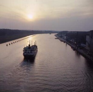 Holstein. Nordostsee Kanal : Kiel-Holtenau. Frachter verläßt Holtenau Richtung Süden in der Abendsonne auf dem Nord-Ostsee-Kanal