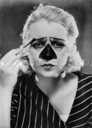 Frau schminkt sich als Clown