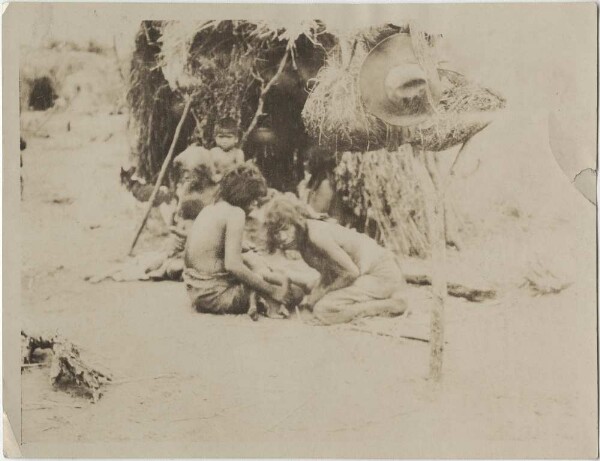 Ashluslay medicine man blowing on a sick child