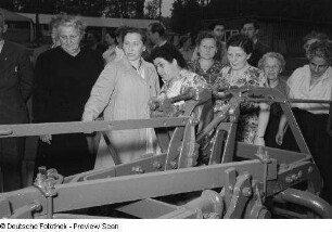 Besucher vor einem landwirtschaftlichen Gerät