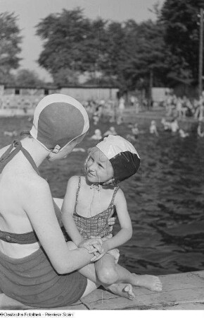 Porträt Renate Rössings in Badebekleidung mit einem kleinen Mädchen am Beckenrand im Freibad