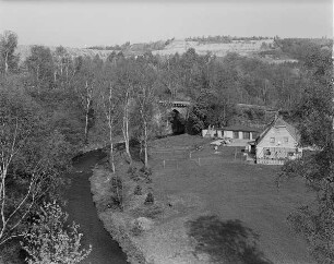 Freiberg-Halsbach. Freiberger Mulde mit Straßenbrücke der Alten Dresdner Straße (1576). Blick von der Straßenbrücke (B 173) nach Nordwesten gegen Wohnhaus (ehemalige Schwefelhütte), Talstraße 9 und alte Muldenbrücke