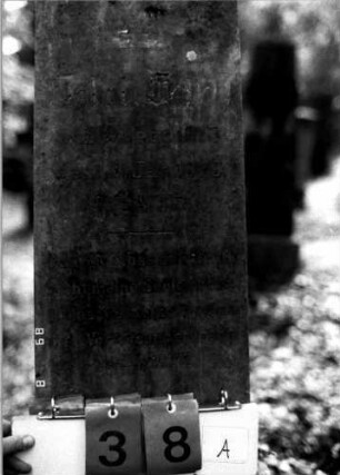 Grabstein 38 (Index: 100109261) Material: Obelisk rosa Marmor, Sockel (?), eingelassene Bleibuchstaben Zustand: verwittert Maße HxBxT: 142x39x22 cm Beschreibung: Obelisk, Sockel rustica Symbolik: Rose Steinmetz: Beerli Besonderheit: Nummer auf Rückseite: 135: Grabstein 38A