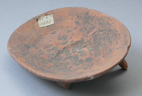 Three-footed clay bowl