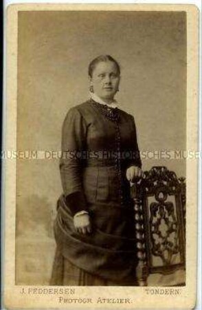 Frau im dunklen Kleid an Stuhl gelehnt, Carte de Visite