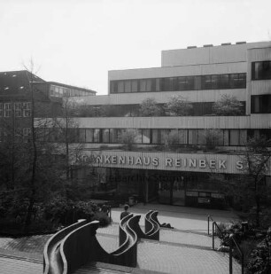 Krankenhäuser: Krankenhaus Reinbek St. Adolf-Stift: Hamburger Straße: Mittelbau mit Namenszug: vorn Treppe: darauf Personen: rechts und links davon Grünanlage mit Büschen und Bäumen: hinten links Erweiterungsbau