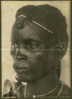 Kopfstudie eines Massai mit traditioneller Haartracht in der Halbfrontalen von links