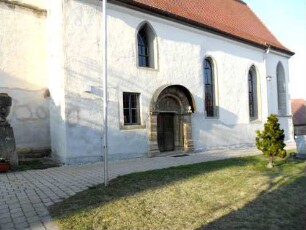 Langhaus (romanisch 13 Jh - später überarbeitet) über Traufseite Süd mit romanischem Portal in Übersicht