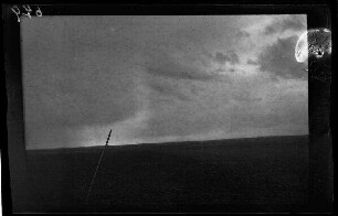 Bei Metz-en-Couture (Dep. Pas-de-Calais, Frankreich): wolkenverhangener dunkler Himmel über eine Ackerfläche