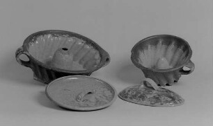 Zwei Napfkuchenbackformen (Bebe), Topfdeckel (Stürze) und Pfannendeckel : Zwei Napfkuchenbackformen (Bebe), Topfdeckel (Stürze) und Pfannendeckel (Letztes Frohburger Gebrauchsgeschirr vor 1910). Irdenware, Engobe, bemalt, glasiert. Frohburg: Museum im Schloß Frohburg V 423/95, V 425/95, V 424/95, V 426/95
