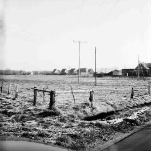 Wiemerskamp: Wulksfelder Weg: Blick auf den Ortsteil: vorn Wiesen mit Zäunen und Strommasten: hinten rechts Bauerngehöft: hinten Mitte Einfamilienhäuser: Winter