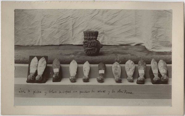 Stone idol depicting the god Tlaloc. Eleven flint blades with a spherical holder made of copal resin at each end.