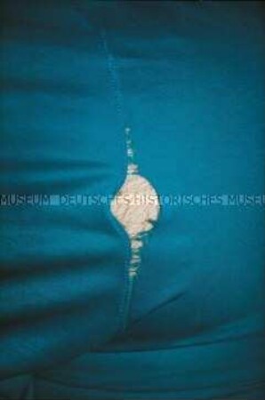 Nahaufnahme einer blauen Hose mit gerissener Naht (Altersgruppe bis 14)
