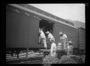 Bahnfahrt Veracruz - Mexiko (beide Mexiko): Mexikaner beim Beladen eines Güterwaggons mit Flüssigkeitsbehältern (Alkoholisches (?))