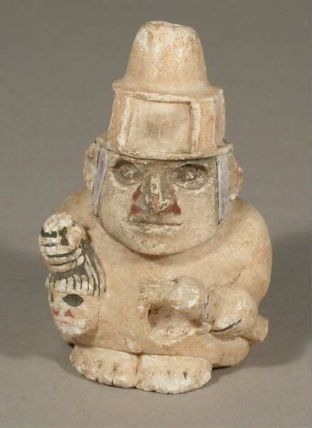 Stehende anthropomorphe Figur mit Trophäenkopf