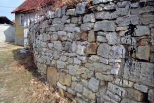 Kalksteinmauer um ein altes Bauerngehöft
