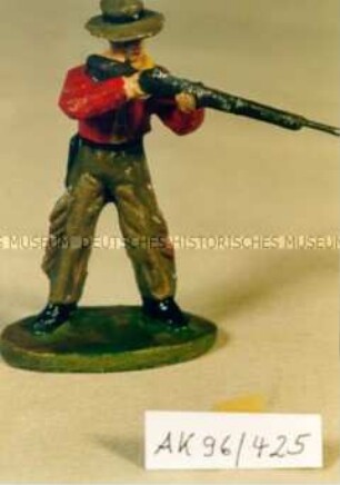 Stehender Cowboy, mit Gewehr schießend