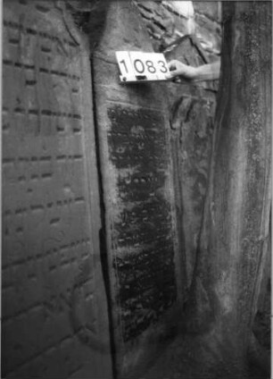 Grabstein 1083 (Index: 99630586) Material: Sandstein Zustand: stark verwittert mit Textverlust Maße HxBxT: 131x49x9 cm Beschreibung: Stele mit eingezogenem Rundbogenabschluß, rechteckiges Schriftfeld eingetieft: Grabstein 1083