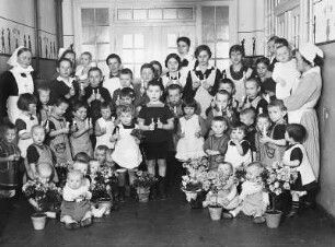 Coswig. Kreispflegeheim Wettinstift (1913, 1919-um 1935; E. Pönisch). Kindergruppe mit Kerzen und Blumentöpfen, dahinter Diakonissen und Betreuerinnen