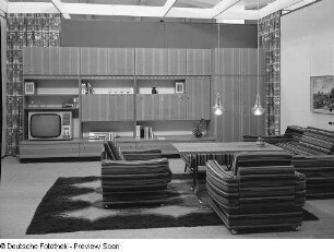 Sitzgruppe : Wohnzimmermöbel (1973; VEB Möbelkombinat Zeulenroda-Triebes (ZEUTRIE)). Ansicht mit Anbauwand und Sitzgruppe mit Couchtisch
