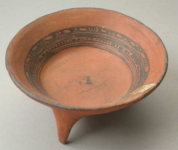 Three-footed clay bowl