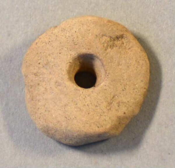 pierced stone disc