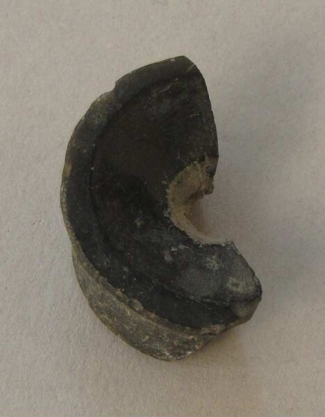 Fragment of an ear peg made of obsidian