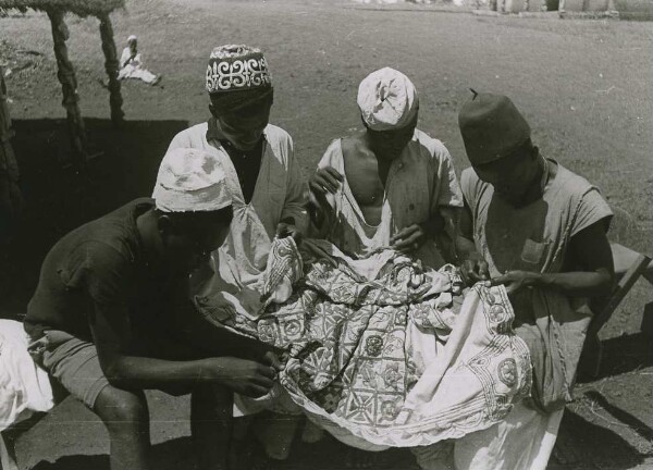 Cover embroidery. Three or four men sometimes work on the hand-woven embroidery, which is made up of five centimetre wide weaving strips