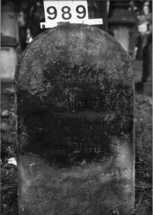 Grabstein 989 (Index: 99630491) Material: Sandstein Zustand: stark verwittert Maße HxBxT: 75x45x16 cm Beschreibung: Stele mit Rundbogenabschluß: Grabstein 989