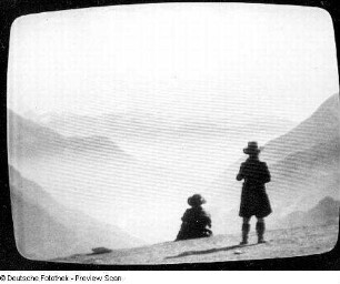 Fernsehbild einer Berglandschaft mit zwei Personen