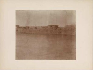 Samarra : Blick vom Tigris auf die Häuser von Samarra. Vor einem Haus sitzen Männer.