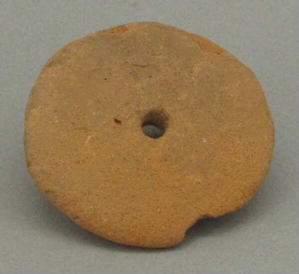 Pierced clay disc