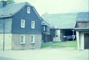 Blick in einen Bauernhof, links Wohnhaus, hinten Scheune