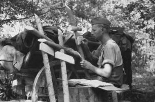 Zweiter Weltkrieg. Rußland, Oblast Belgorod. Nach den Kampfhandlungen. Franz Grasser beim Beschriften von Grabkreuzen