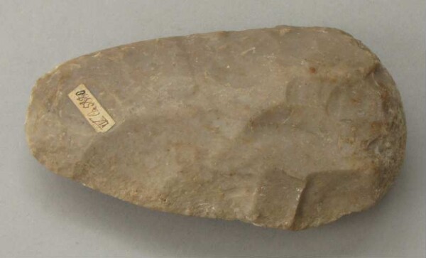 Fragment of a stone axe used as a tapping stone