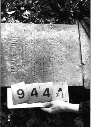 Grabstein 944 (Index: 99753158) Material: Sandstein Zustand: stark verwitt/fast völl. Textverlust Maße HxBxT: 108x42x24 cm Beschreibung: Stele, Sockel, Giebel: Grabstein 944B
