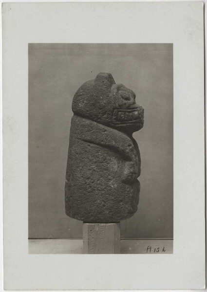 Stone figure of a squatting jaguar made of limestone. Height 40 cm. Side view.