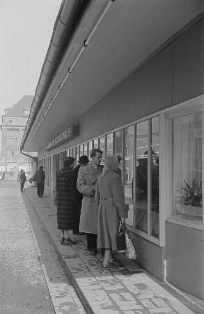 Messebesucher betrachten ein Schaufenster