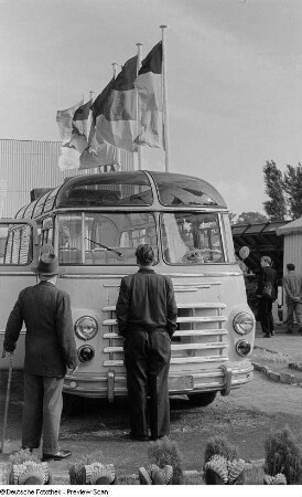Besucher der Leipziger Herbstmesse 1954 betrachten einen Reisebus