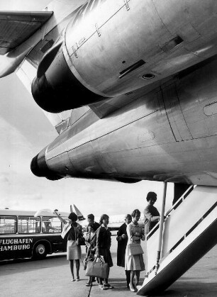 Auf dem Rollfeld des Hamburger Flughafens Fuhlsbüttel besteigen Passagiere über eine Gangway das wartende Flugzeug