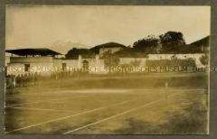 Askari und Afrikaner bei einem Tennisplatz der Boma in Alt-Moschi