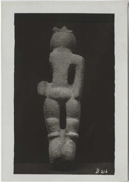 Male stone figure with bird helmet mask, back. (Arm and smaller parts broken off). Collection Guillermo de Heredia.