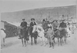 Akureyri (Island). Passagiere und Offiziere des Hochseepassagierdampfers "Victoria Luise" auf Islandpferden gegen Fischereihafen am Eyjafjord. Blick nach Nordost