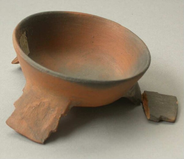 Three-footed clay bowl