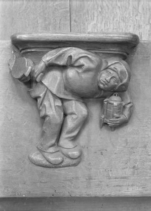 Sechste Misericordie: Mann mit Lampe und Blasebalg