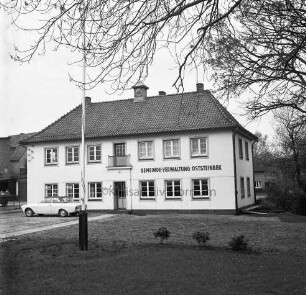 Gemeindeverwaltung: Möllner Landstraße: altes Rathaus: davor Grünanlage mit Fahnenmast: links Pkw: hinten Bäume