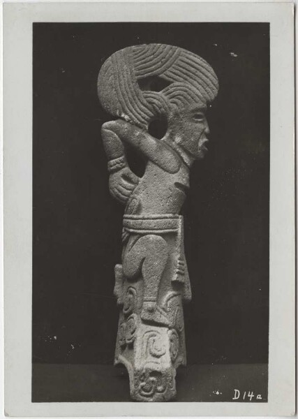 Sacrificed warrior with fantastic headdress. Side view of the stone sculpture. -Palma-