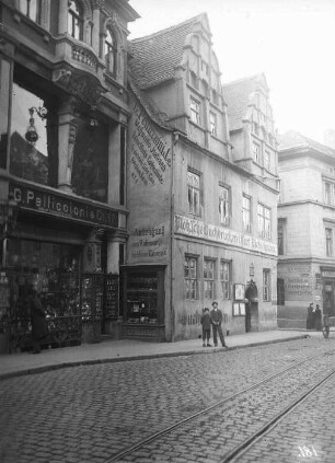 Blick durch Große Ulrichstraße auf zwei Geschäfts- und Wohngebäude
