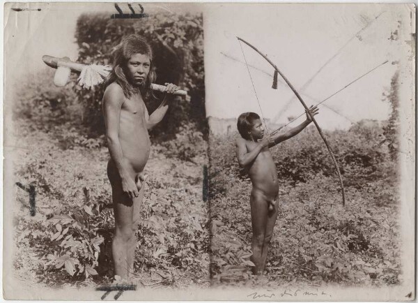 Young Kayapó men with ceremonial bow or stone axe